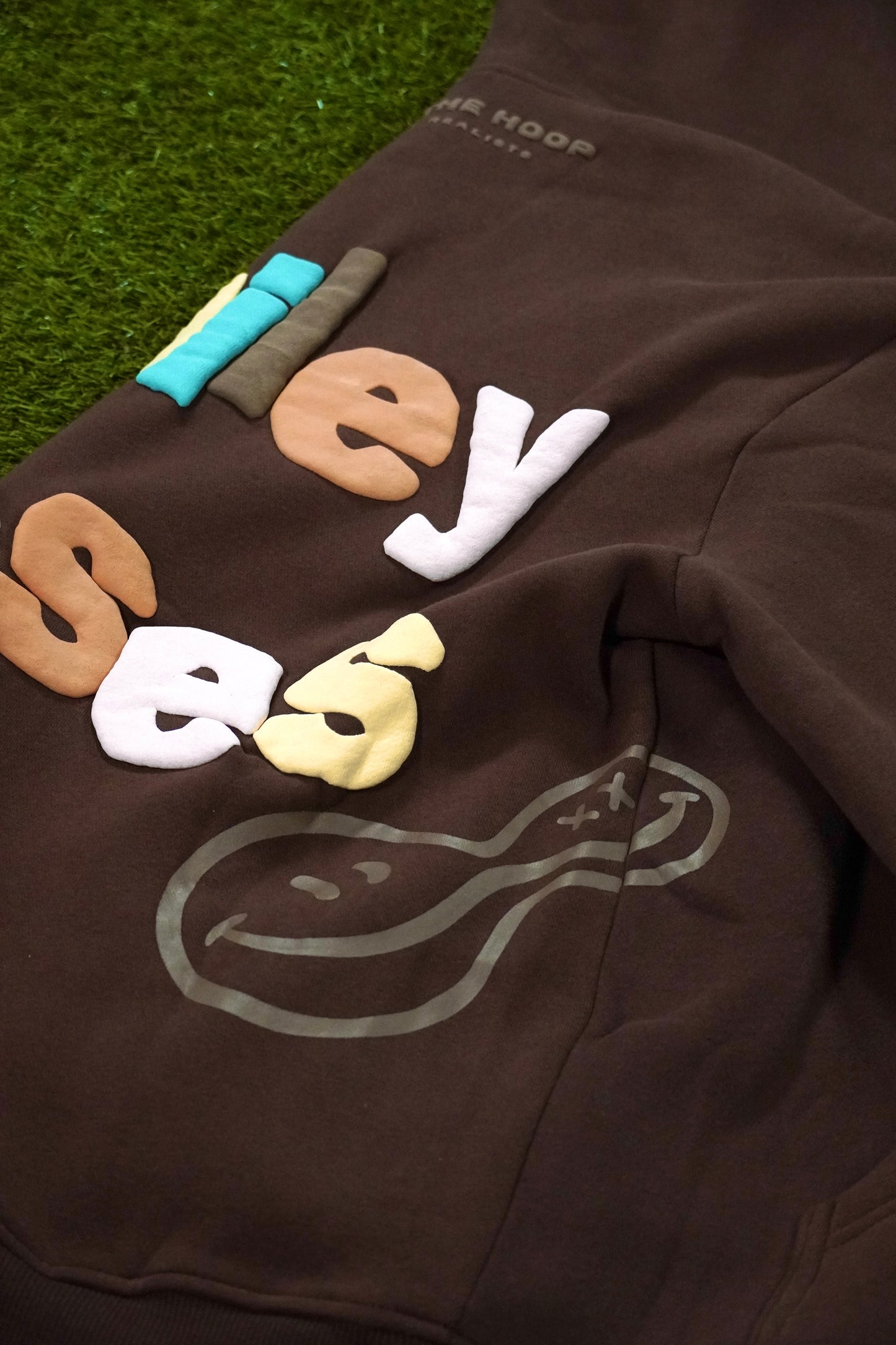 "Smiley Phases" Hoodie - Cosmic Brownie