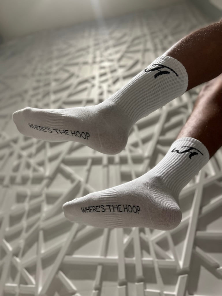 Model wearing White Everyday Socks, showing Where's The Hoop on bottom of foot  and WTH Logo